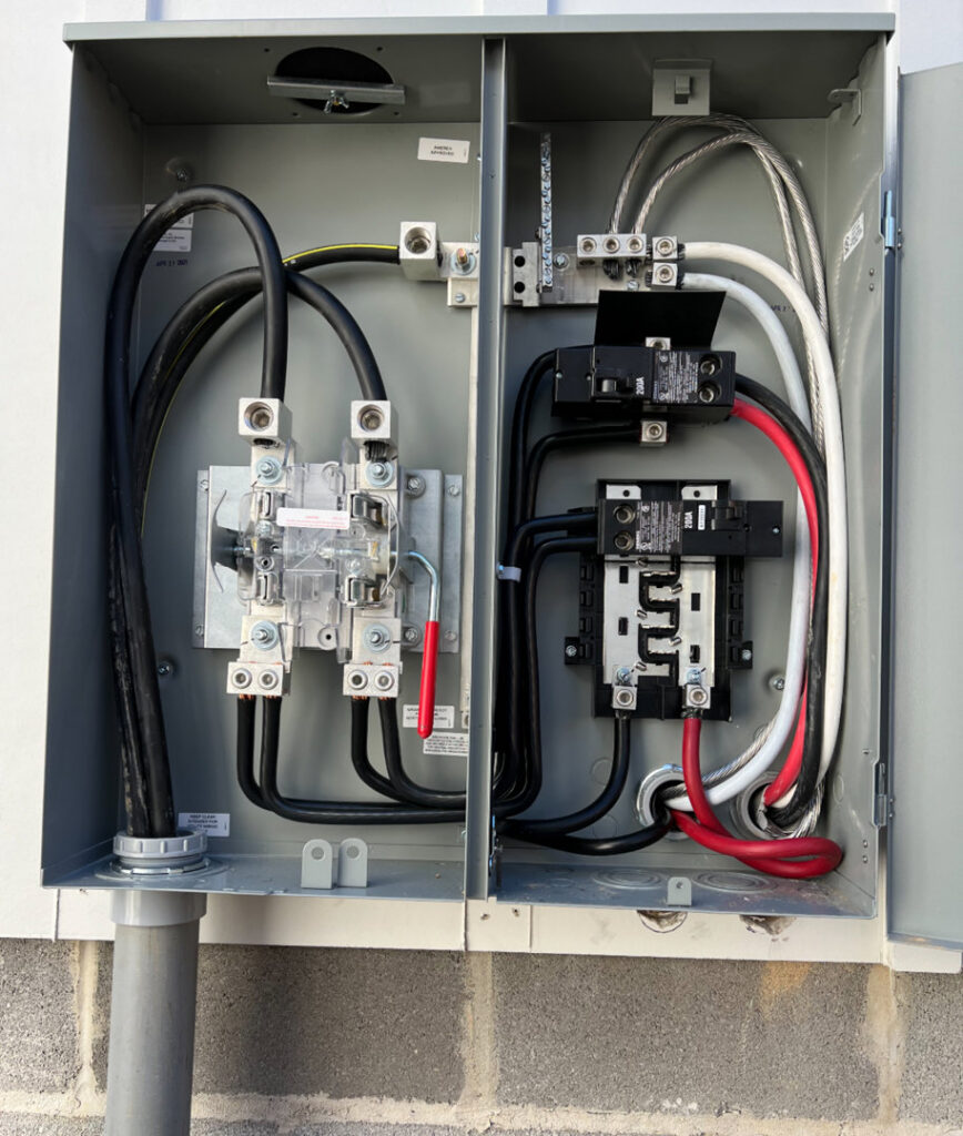 An open electrical meter panel showing wiring and breakers installed by Raschke & Sons Electric in Chattanooga, TN