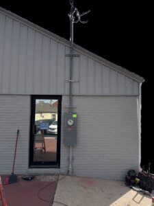 Exterior electrical meter and conduit installation on a building by Powered Electrical & Lighting Services LLC in Springfield, MO.