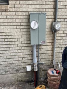 New electrical meter and service panel installation on a brick home by All Aboard Services in Farr West, UT.