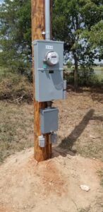 An electrical meter and service panel installed on a utility pole by BIG Services in Springfield, MO.