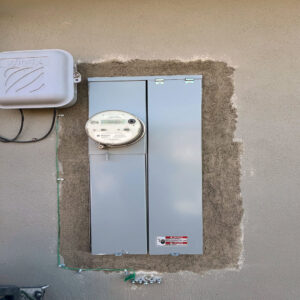 An outdoor electrical meter and main service panel installed on a residential wall by Fuse Service HVAC & Electrical Sacramento, CA