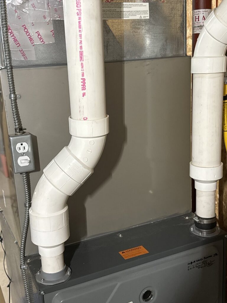 A newly installed electrical outlet next to a furnace by Kelly Heating & Electric, LLC in Eau Claire, WI.