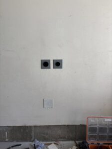 New electrical outlet and receptacle installation on a white wall by Regal Electrical Services in West Jordan, UT.