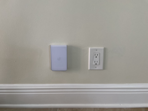 A newly installed electrical outlet and smart device on a wall by One Installation Inc. in Davie, FL