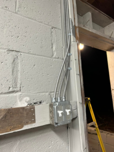 An electrician testing an electrical outlet with a receptacle tester by Ele Hvac Solutions Inc. in Birmingham, AL