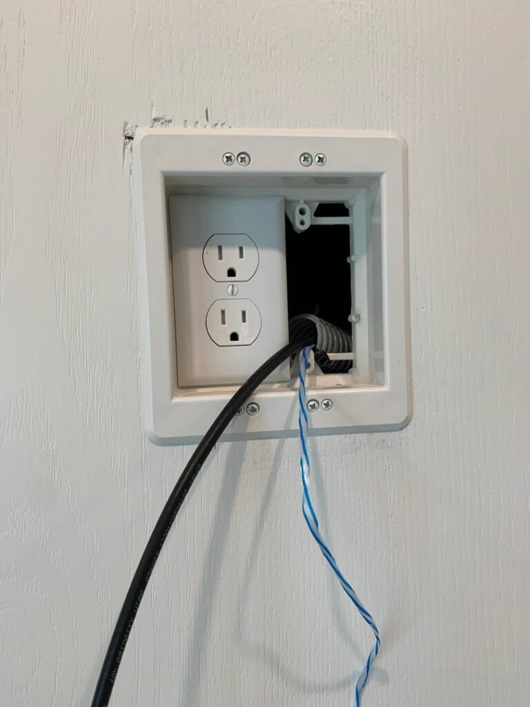 An electrician wiring a new electrical outlet for Coffin Electric in Grimes, IA.