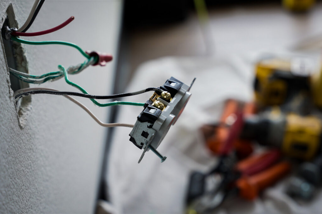 An electrical outlet being wired and installed, showcasing expert work by Mister Sparky NWA in Springdale, AR.