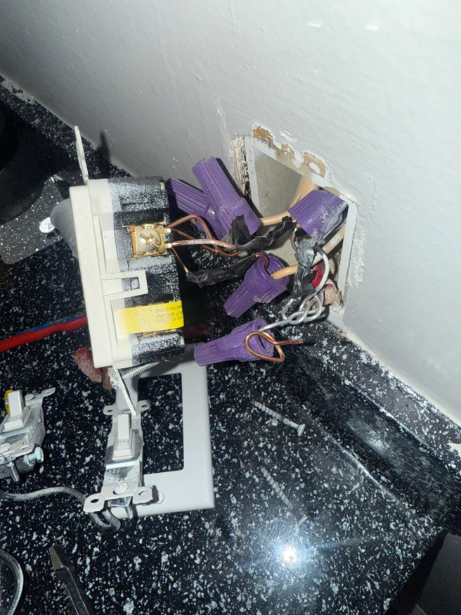 Exposed electrical outlet wiring with wire nuts during a repair or installation by Ask Electricians in Los Angeles, CA.