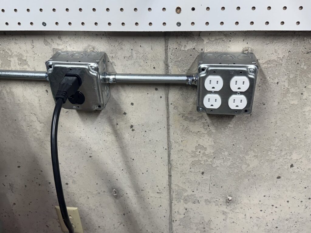 New electrical outlets and conduit installed on a concrete wall by Swartz Electric in Colorado Springs, CO.