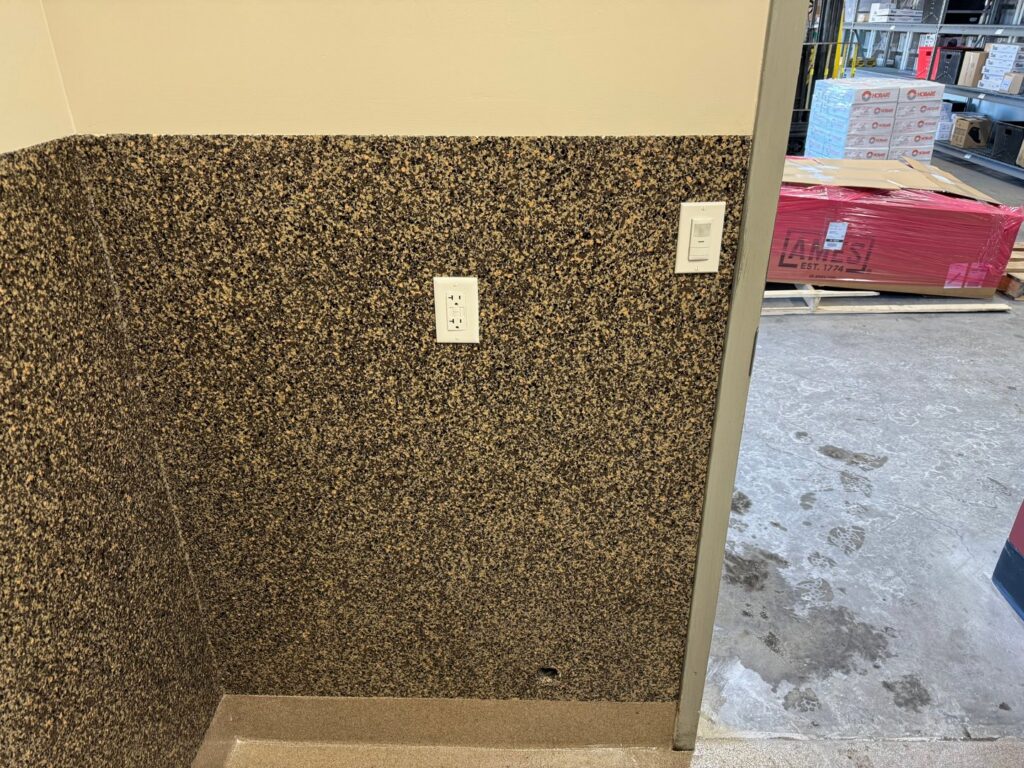 Newly installed electrical outlets and a light switch on a textured wall by AC-DC Electric in Severance, CO.