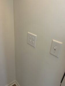 Newly installed electrical outlets and a light switch on a wall by Strother & Son Electric in Mount Pleasant, SC.