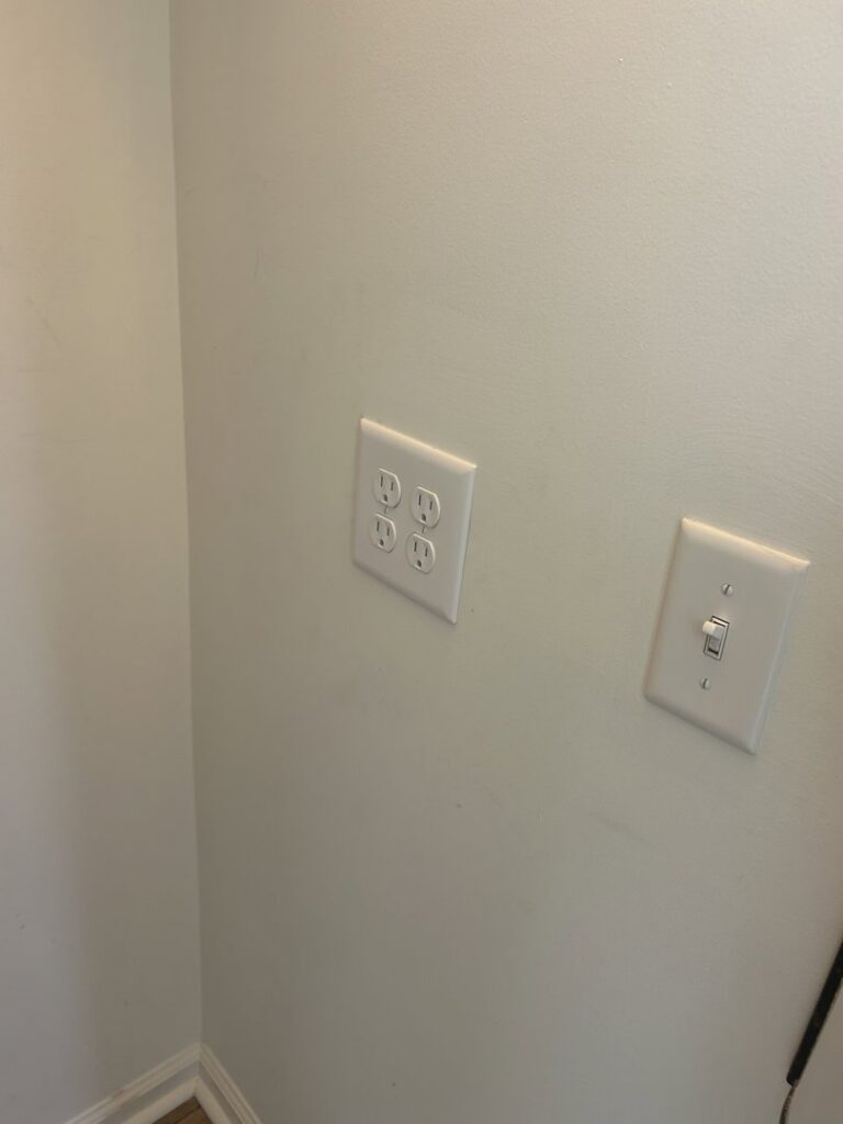 Newly installed electrical outlets and a light switch on a wall by Strother & Son Electric in Mount Pleasant, SC.