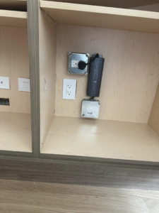 Electrical outlets and a power supply unit installed inside a cabinet by Nech Electric Services Inc. in Chicago, IL.