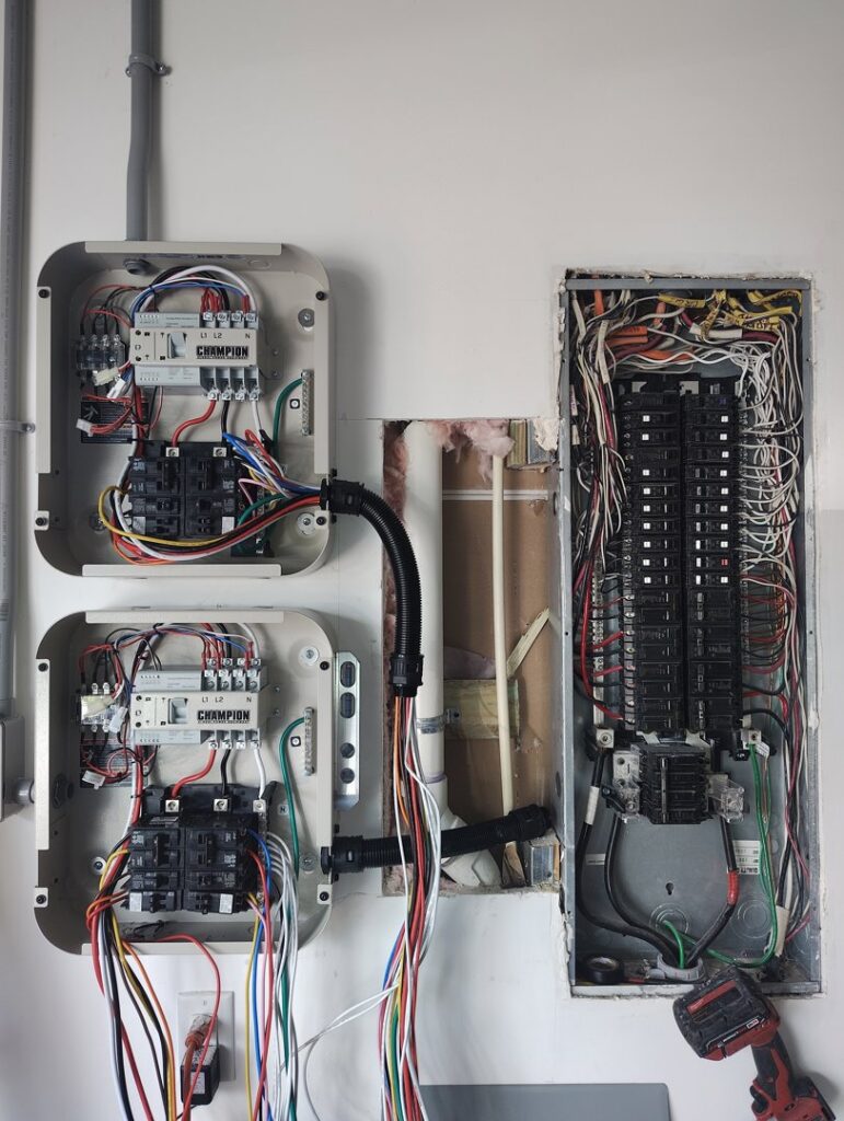 Complex electrical panel and transfer switch installation with exposed wiring, demonstrating expert work by Envision Electrical Solutions in Fort Lauderdale, FL.