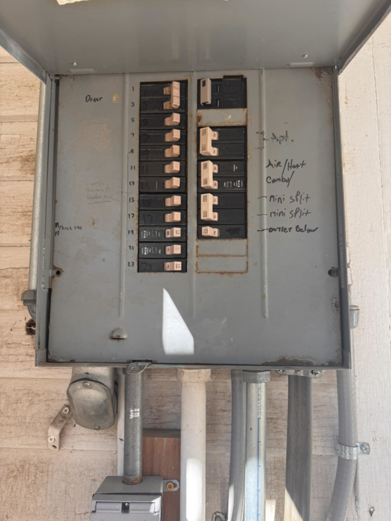 An open electrical panel or breaker box showing circuit breakers, serviced by Aegis Electric in Albuquerque, NM.