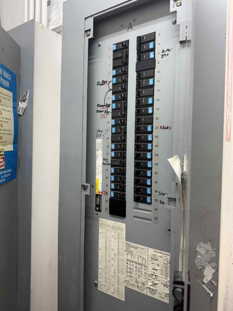 An open electrical panel with multiple circuit breakers, showing electrical work by ETF Electric LLC in Las Vegas, NV.