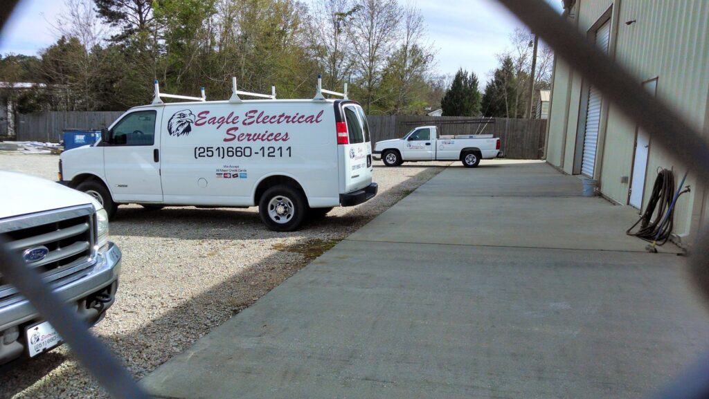 An open electrical panel or breaker box showing wiring and circuit breakers, serviced by Eagle Electrical Services Inc in Mobile, AL