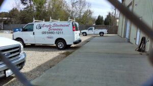 An open electrical panel or breaker box showing wiring and circuit breakers, serviced by Eagle Electrical Services Inc in Mobile, AL