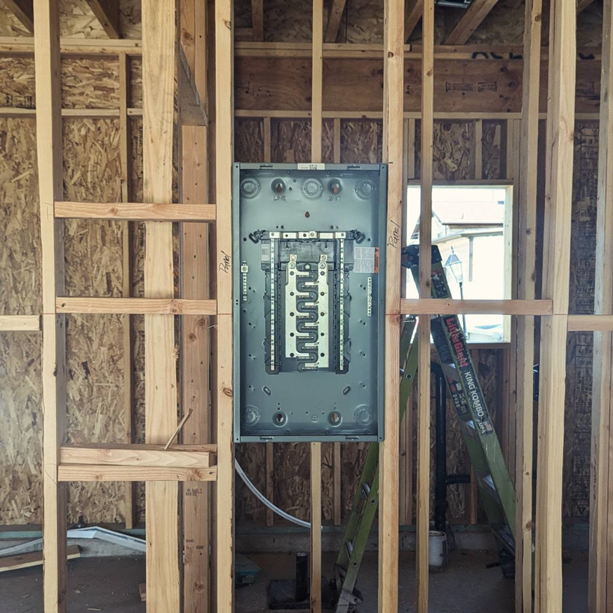 An electrical panel with its cover open, revealing bus bars and wiring during installation by Lara Electric in Miami, FL.