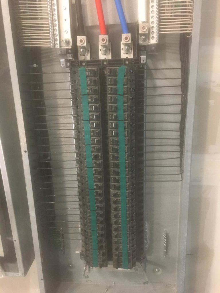 An interior view of an electrical panel showing bus bars and organized wiring by Shines Electric in Orlando, FL.