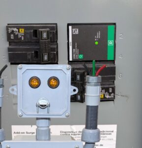 A close-up of an electrical panel with circuit breakers and a surge protection device installed by The Wire Guy in San Jose, CA.