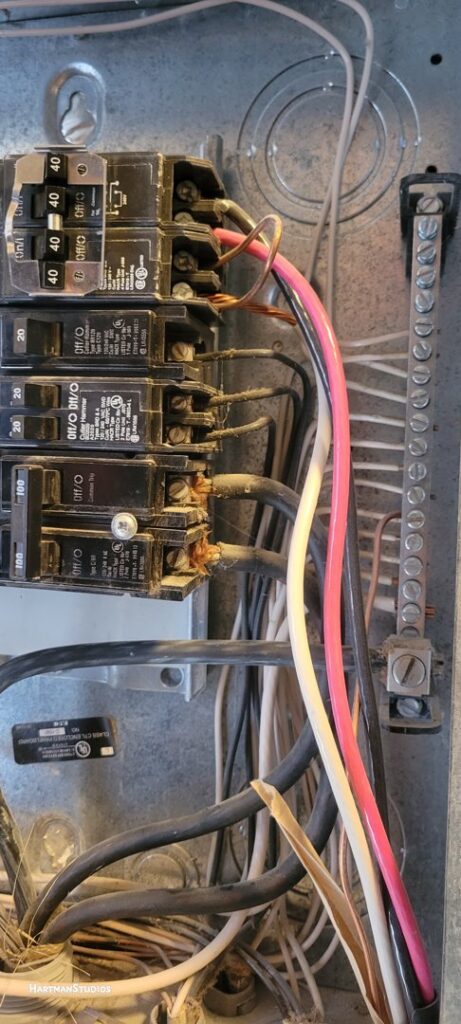 The interior of an electrical panel showing circuit breakers and wiring, serviced by All Aboard Services in Farr West, UT.