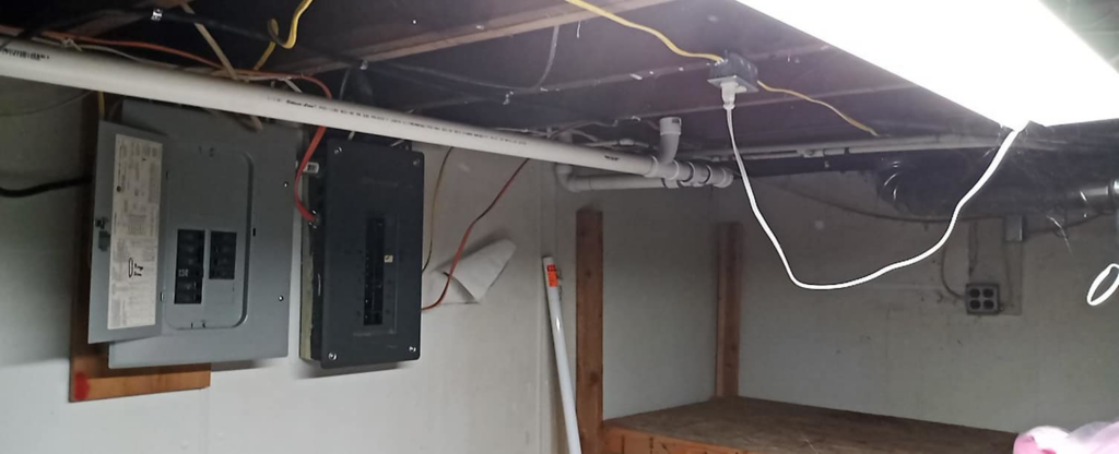 An electrical panel and conduit installed in a utility area, showcasing electrical work by Benson Electric LLC in Owensboro, KY.