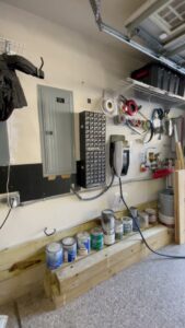 An electrical panel and EV charger installed in a garage by Royal Electric Services in Raleigh, NC