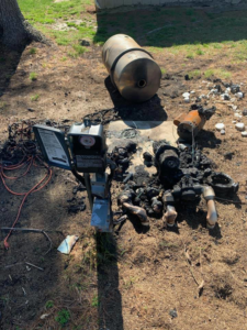 A burnt electrical panel or pump control box showing fire damage, indicating a need for electrical repair by K E Troutman Electrical Contractor in Newark, DE.