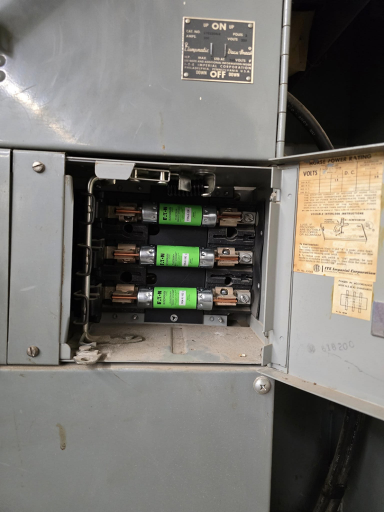 Close-up view of an open electrical panel showing fuses, serviced by Mastermind Electric, LLC in Johnson City, TN