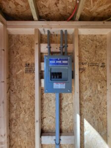 An electrical panel installed in a new construction home with wood framing by Ozzy Electric in Jacksonville, FL.