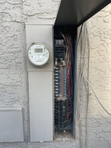 An open electrical panel and meter box showing wiring and breakers, indicating an inspection or upgrade by AAA Electrical Services in Sacramento, CA.
