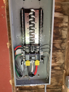 An open electrical panel with wiring, showing a professional installation by Affordable Electric, LLC in Kearney, NE.