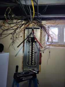An open electrical panel during installation or repair, with numerous wires being connected by Maiolo Electric in Pittsburgh, PA.