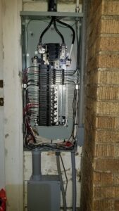 An open electrical panel with wiring and circuit breakers, showcasing an electrician's work by Anytime Electrical in Baton Rouge, LA.