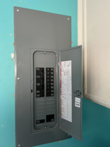 A newly installed electrical panel with breakers open for inspection by Ark Electrical Service in Tomball, TX