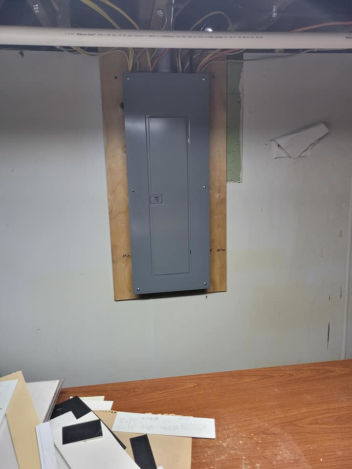 A newly installed electrical panel (breaker box) on a wall, showing electrical wiring above, by Benson Electric LLC in Owensboro, KY.