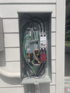 An open electrical panel with wiring and components installed by Camo Construction & Electric in Lake Charles, LA.