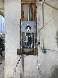 An electrical panel installation in progress with exposed wiring and conduit, performed by Canyon Electric Company, Inc. in North Las Vegas, NV
