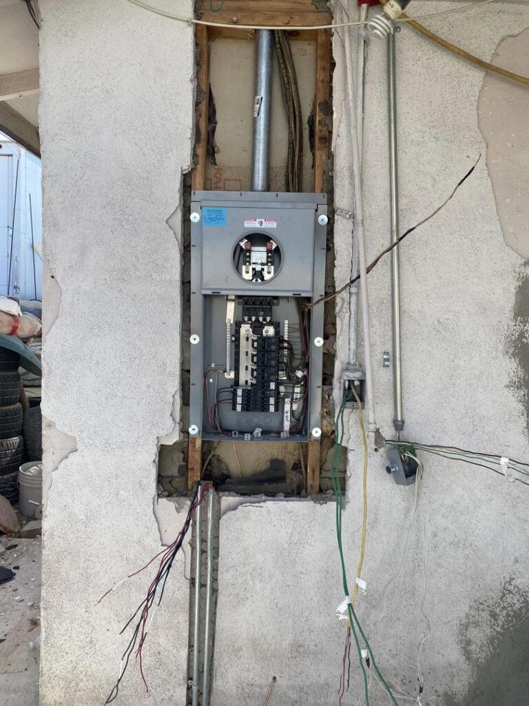 An electrical panel installation in progress with exposed wiring and conduit, performed by Canyon Electric Company, Inc. in North Las Vegas, NV