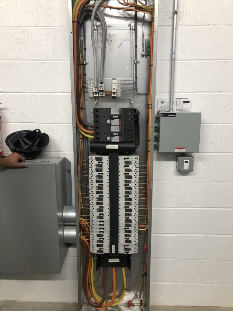 An open electrical panel with circuit breakers and wiring installed by Cardinal Electric in Sayreville, NJ