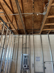 An electrical panel and conduit wiring being installed in a commercial building by TF Electrical Solutions in Omaha, NE.