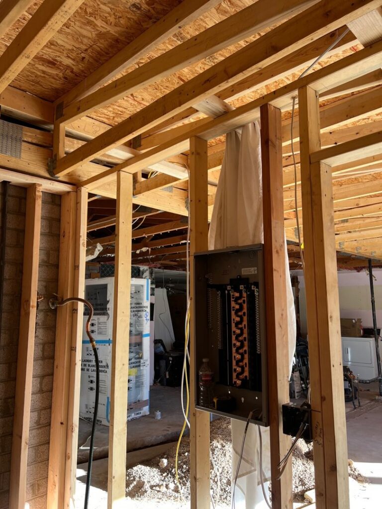 An electrical panel being installed in a wall during construction by Gilmore Electrical in Saint Louis, MO