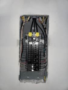 An electrical panel installation with wiring visible, performed by Delta Current Electric in Jonesboro, AR.