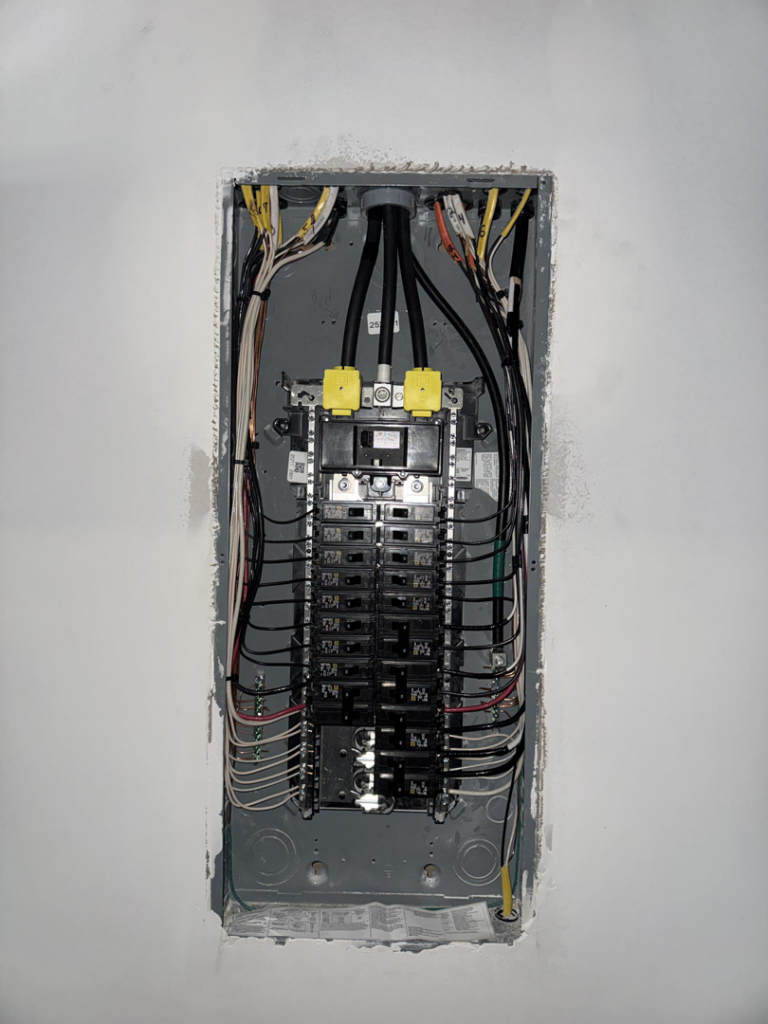 An electrical panel installation with wiring visible, performed by Delta Current Electric in Jonesboro, AR.