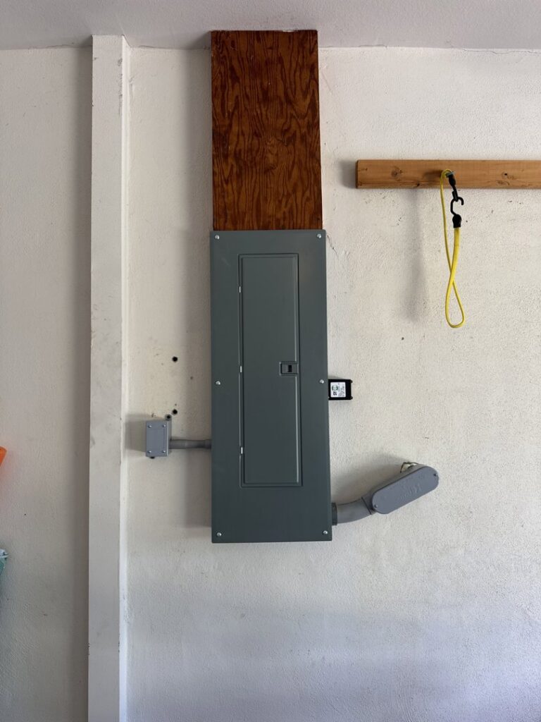 A newly installed electrical panel with conduit connections by Dynamic Electric in Cape Coral, FL.