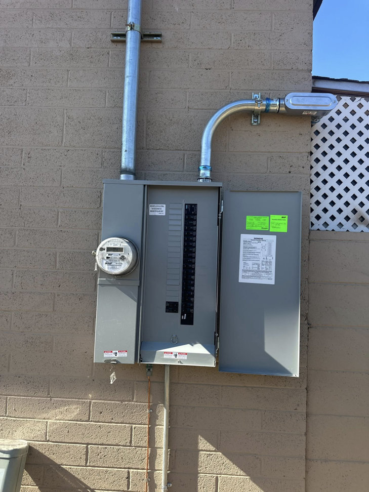 An electrical panel and meter installed on a brick building by Farris Electric LLC in Glendale, AZ.