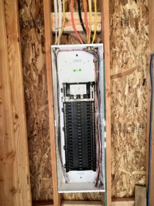 An electrical panel with wiring installed in a framed wall by Watts Up Electric in Crystal Lake, IL.