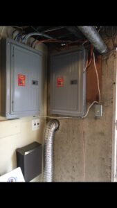 Two new electrical panels installed in a basement by John Fean Electrician Inc. in Philadelphia, PA.
