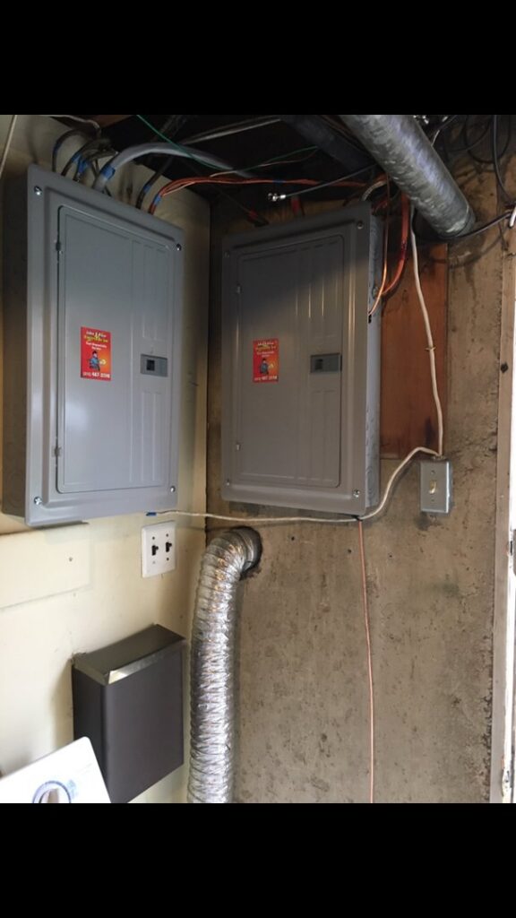 Two new electrical panels installed in a basement by John Fean Electrician Inc. in Philadelphia, PA.
